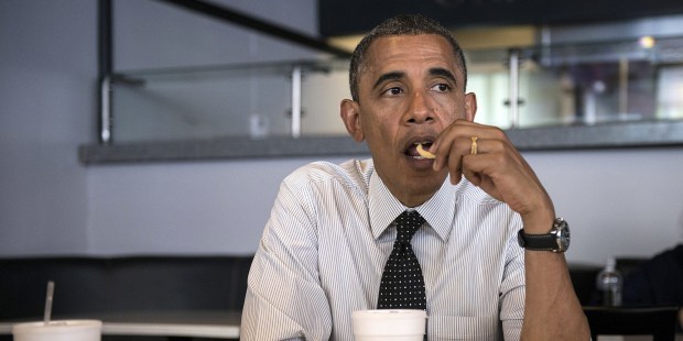 US President Barack Obama eats a french fry while meeting with supporters about voter registration at OMG Burgers on September 20, 2012 in Miami, Florida.  Obama is traveling to Florida for the day to participate in a taping for Univision in Miami before attending a campaign event in Tampa.  AFP PHOTO/Brendan SMIALOWSKI        (Photo credit should read BRENDAN SMIALOWSKI/AFP/GettyImages)
